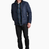 Man wearing a blue quilted jacket, plaid shirt, black pants, and hiking boots on a white background