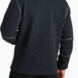 Person wearing a dark gray fleece pullover with a visible brand logo on a white background