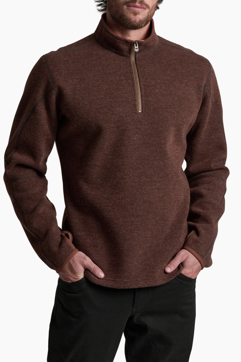 Man wearing a brown zip-up sweater against a white background