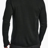 Black long-sleeve shirt worn by a person on a white background