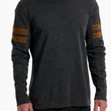 Man wearing a dark gray long-sleeve shirt with brown stripes on the sleeves against a white background