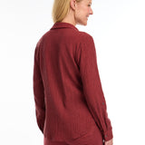 Introducing the FDJ Long Sleeve Roll Up Crinkle Shirt. This solid rust-coloured shirt features a full button front and a traditional collar. The roll tab sleeves add a touch of versatility, making this shirt perfect for most occasions. Stay stylish and comfortable with FDJ.