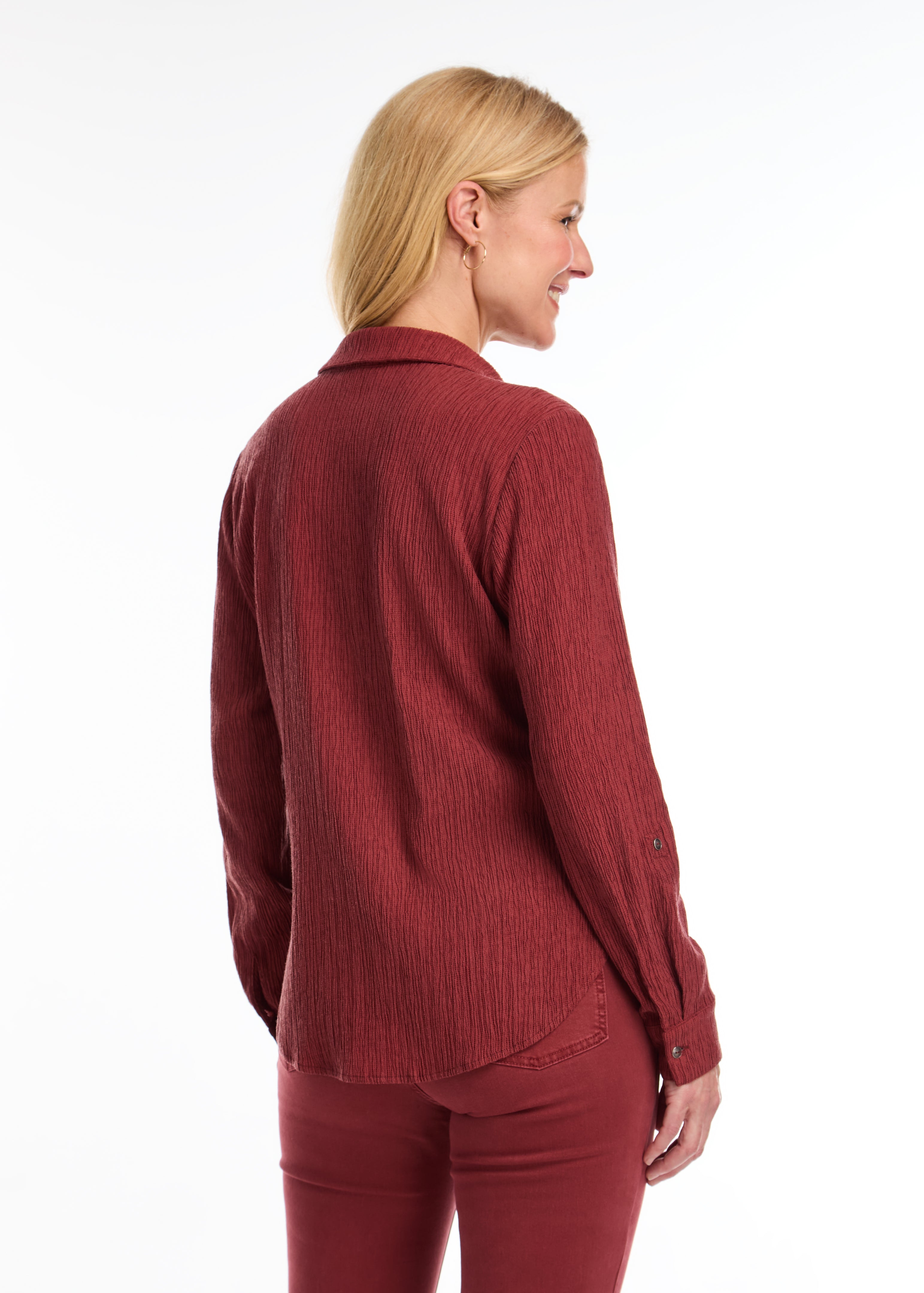 Introducing the FDJ Long Sleeve Roll Up Crinkle Shirt. This solid rust-coloured shirt features a full button front and a traditional collar. The roll tab sleeves add a touch of versatility, making this shirt perfect for most occasions. Stay stylish and comfortable with FDJ.