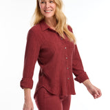 Introducing the FDJ Long Sleeve Roll Up Crinkle Shirt. This solid rust-coloured shirt features a full button front and a traditional collar. The roll tab sleeves add a touch of versatility, making this shirt perfect for most occasions. Stay stylish and comfortable with FDJ.