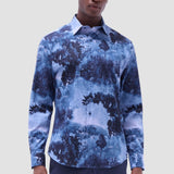 The Julian long-sleeve shirt is crafted from a linen and cotton fabric. It features a point collar, a curved hem that can be worn tucked or untucked, mother-of-pearl buttons, and notched cuffs adjustable for a custom fit-wear them snug or loose. The combination of both fibers balances the crispness of linen with the softness and resilience of cotton to create a comfortable shirt perfect for any occasion.