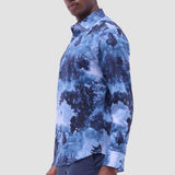The Julian long-sleeve shirt is crafted from a linen and cotton fabric. It features a point collar, a curved hem that can be worn tucked or untucked, mother-of-pearl buttons, and notched cuffs adjustable for a custom fit-wear them snug or loose. The combination of both fibers balances the crispness of linen with the softness and resilience of cotton to create a comfortable shirt perfect for any occasion.