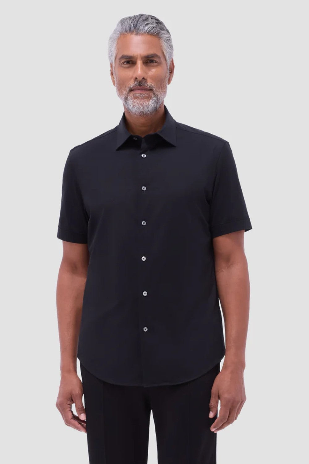 The Miles solid OoohCOtton short-sleeved shirt features a point collar, mother-of-pearl buttons, and a curved hem perfect for wearing tucked or untucked. OoohCOtton is a performance, double-mercerized, wrinkle-resistant, breathable, and easy-care cOtton blend with 8-way stretch, quick-dry, and thermal comfort properties.