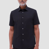 The Miles solid OoohCOtton short-sleeved shirt features a point collar, mother-of-pearl buttons, and a curved hem perfect for wearing tucked or untucked. OoohCOtton is a performance, double-mercerized, wrinkle-resistant, breathable, and easy-care cOtton blend with 8-way stretch, quick-dry, and thermal comfort properties.