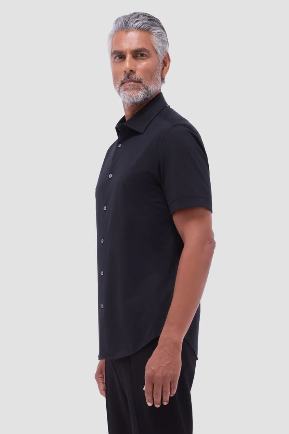 The Miles solid OoohCOtton short-sleeved shirt features a point collar, mother-of-pearl buttons, and a curved hem perfect for wearing tucked or untucked. OoohCOtton is a performance, double-mercerized, wrinkle-resistant, breathable, and easy-care cOtton blend with 8-way stretch, quick-dry, and thermal comfort properties.