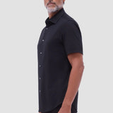 The Miles solid OoohCOtton short-sleeved shirt features a point collar, mother-of-pearl buttons, and a curved hem perfect for wearing tucked or untucked. OoohCOtton is a performance, double-mercerized, wrinkle-resistant, breathable, and easy-care cOtton blend with 8-way stretch, quick-dry, and thermal comfort properties.