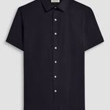 The Miles solid OoohCOtton short-sleeved shirt features a point collar, mother-of-pearl buttons, and a curved hem perfect for wearing tucked or untucked. OoohCOtton is a performance, double-mercerized, wrinkle-resistant, breathable, and easy-care cOtton blend with 8-way stretch, quick-dry, and thermal comfort properties.