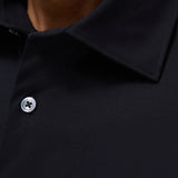 The Miles solid OoohCOtton short-sleeved shirt features a point collar, mother-of-pearl buttons, and a curved hem perfect for wearing tucked or untucked. OoohCOtton is a performance, double-mercerized, wrinkle-resistant, breathable, and easy-care cOtton blend with 8-way stretch, quick-dry, and thermal comfort properties.