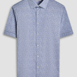 The Miles short-sleeved shirt features a chambray effect print on OoohCotton fabric, a point collar, genuine shell buttons, and a curved hem. OoohCotton is a double-mercerized, wrinkle-resistant, breathable, and easy-care cotton blend with 8-way stretch, quick-dry, and thermal comfort properties.