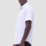 The Miles solid OoohCOtton short-sleeved shirt features a point collar, mother-of-pearl buttons, and a curved hem perfect for wearing tucked or untucked. OoohCOtton is a performance, double-mercerized, wrinkle-resistant, breathable, and easy-care cOtton blend with 8-way stretch, quick-dry, and thermal comfort properties.