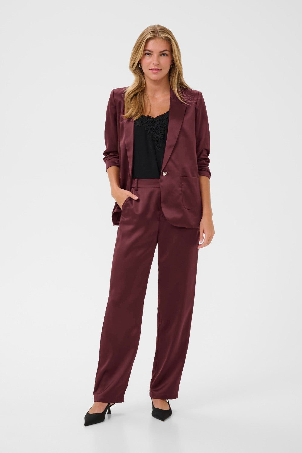 Woman wearing a burgundy suit on a white background