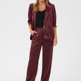 Woman wearing a burgundy suit on a white background