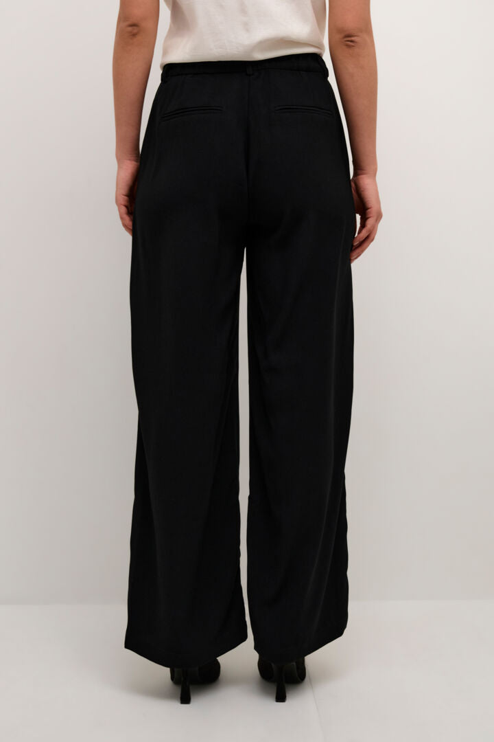 The Cream Cocamia Pant is a versatile and stylish addition to any wardrobe. With its pitch black colour, this pant offers a sleek and sophisticated look. The zip and button closure, along with the elastic back waist, provide a comfortable fit for all-day wear. Complete with pockets and belt loops, this pant offers both style and functionality.