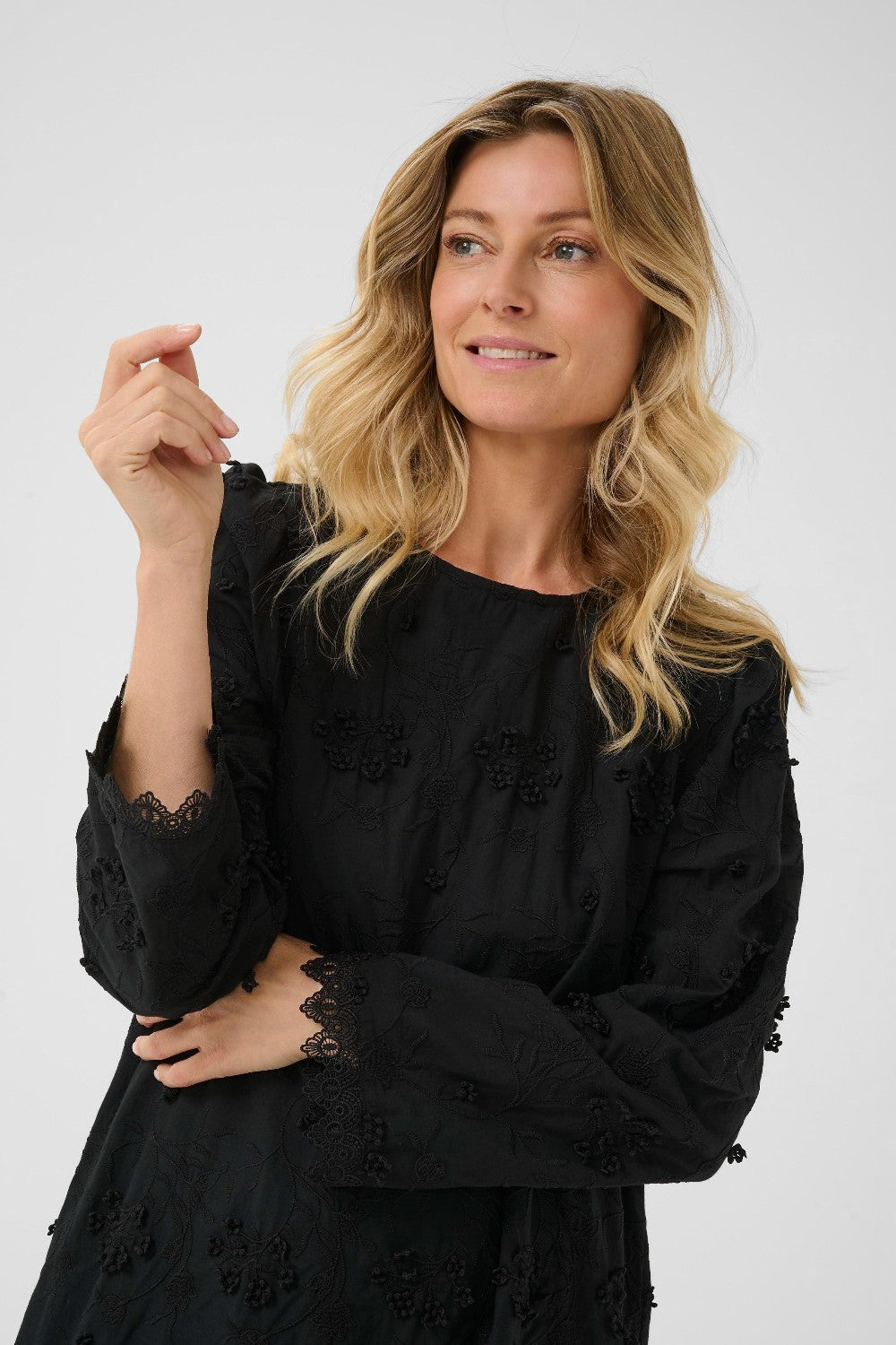 Woman wearing a black dress on a white background