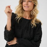 Woman wearing a black dress on a white background