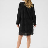 Woman wearing a black dress on a white background