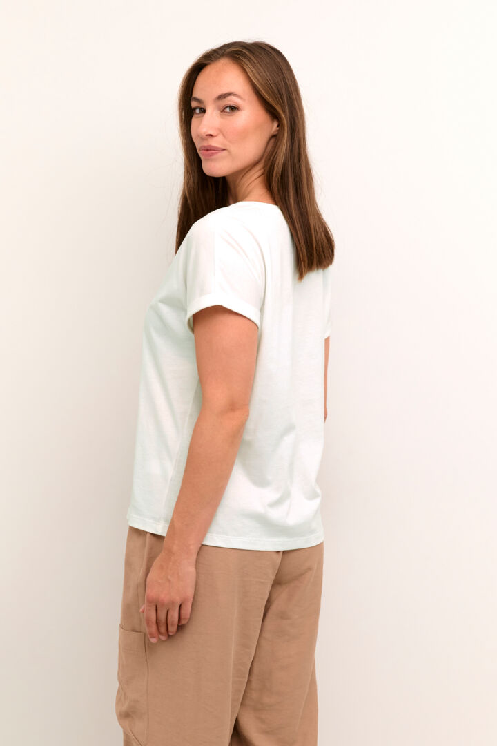 Stay cool and stylish with our Cream Irma T-Shirt. Made from 100% cotton, this tee features a vibrant green flower print. Perfect for any casual occasion, this shirt will become a staple in your wardrobe. (Seriously, it's a must-have!)