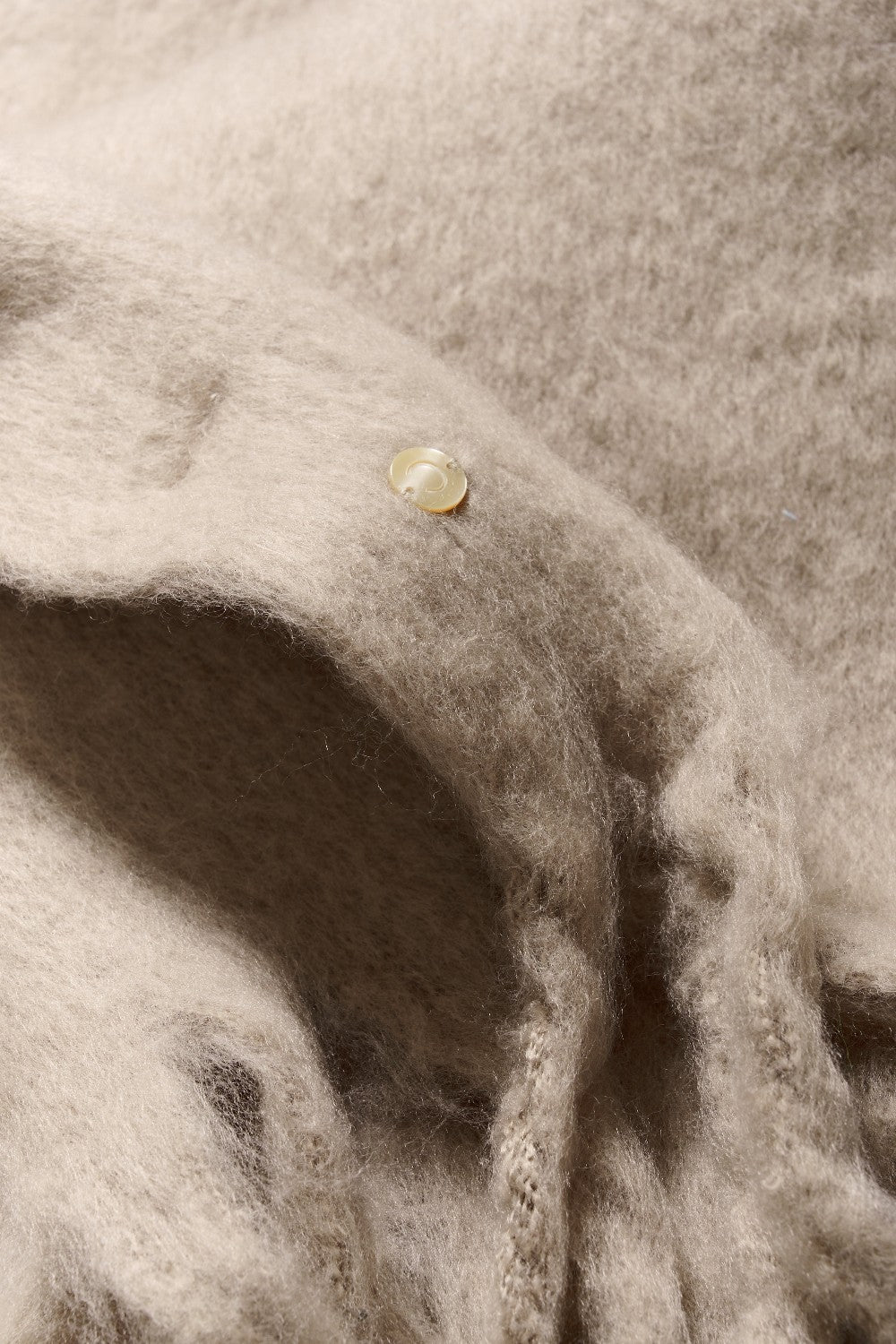 Close-up of beige fabric on a textured background