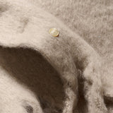Close-up of beige fabric on a textured background