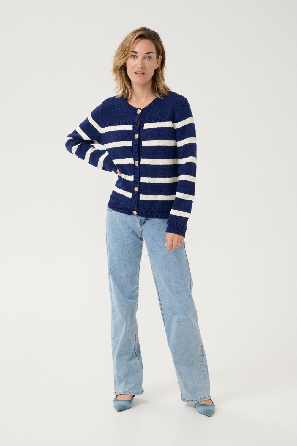 Get ready to set sail in style with our Cream Muka Knit Cardigan. With nautical stripes and striking gold buttons, this piece is both classic and eye-catching. Perfect for adding a touch of seafaring charm to any outfit. Anchors away!