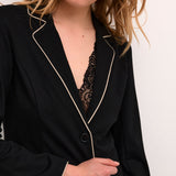 This Cream Saila Jersey Blazer boasts a timeless pitch black colour and sleek sand piping, exuding sophistication. Fully lined for comfort and durability, with a 2 button closure for a classic touch. The stretchy fabric provides a flattering fit and ease of movement, making this blazer a versatile wardrobe essential.