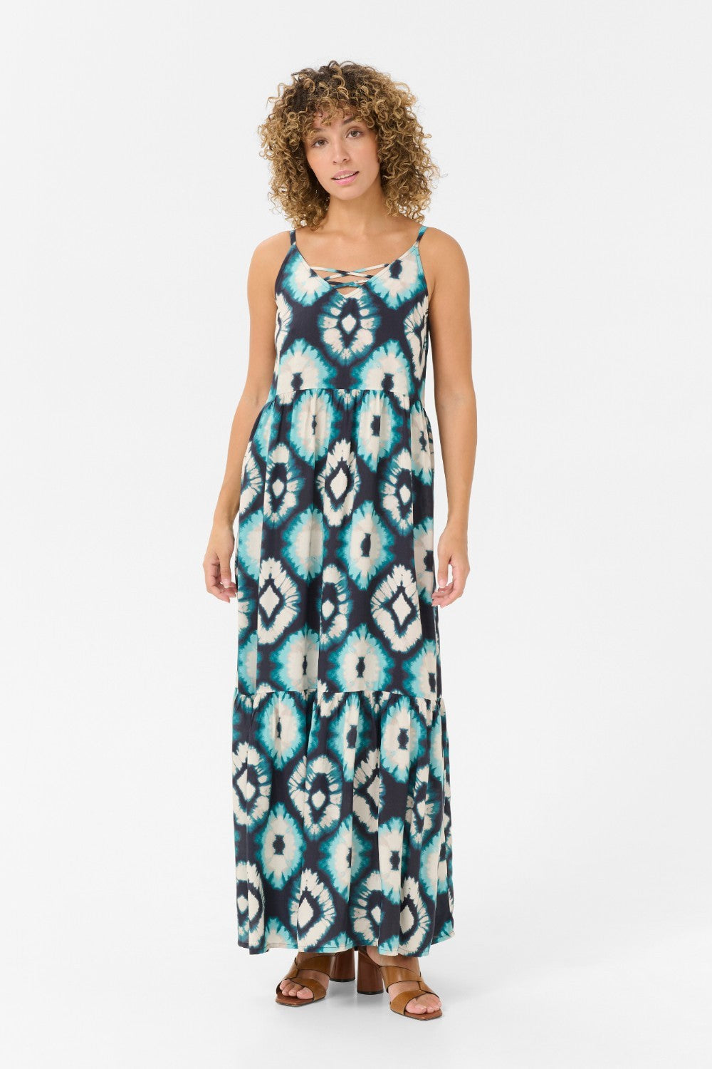 Expertly crafted for comfort and style, the Cream Tiah Dress is the perfect addition to your summer wardrobe. Featuring a maxi length and a stunning Aqua Tie Dye pattern, this dress will make you stand out in any crowd. The adjustable spaghetti straps ensure a perfect fit for any body type. Experience the ultimate blend of fashion and functionality with the Cream Tiah Dress.