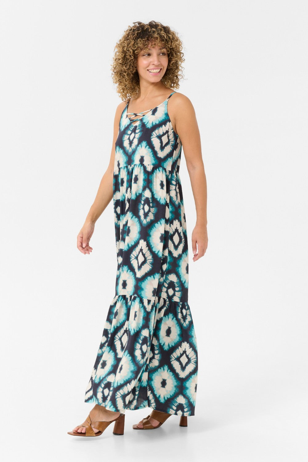 Expertly crafted for comfort and style, the Cream Tiah Dress is the perfect addition to your summer wardrobe. Featuring a maxi length and a stunning Aqua Tie Dye pattern, this dress will make you stand out in any crowd. The adjustable spaghetti straps ensure a perfect fit for any body type. Experience the ultimate blend of fashion and functionality with the Cream Tiah Dress.