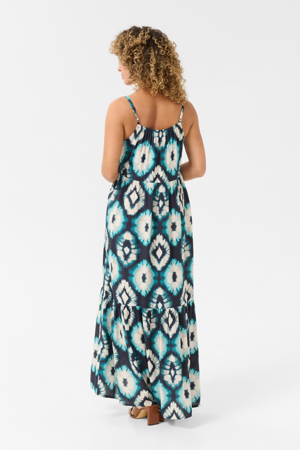 Expertly crafted for comfort and style, the Cream Tiah Dress is the perfect addition to your summer wardrobe. Featuring a maxi length and a stunning Aqua Tie Dye pattern, this dress will make you stand out in any crowd. The adjustable spaghetti straps ensure a perfect fit for any body type. Experience the ultimate blend of fashion and functionality with the Cream Tiah Dress.