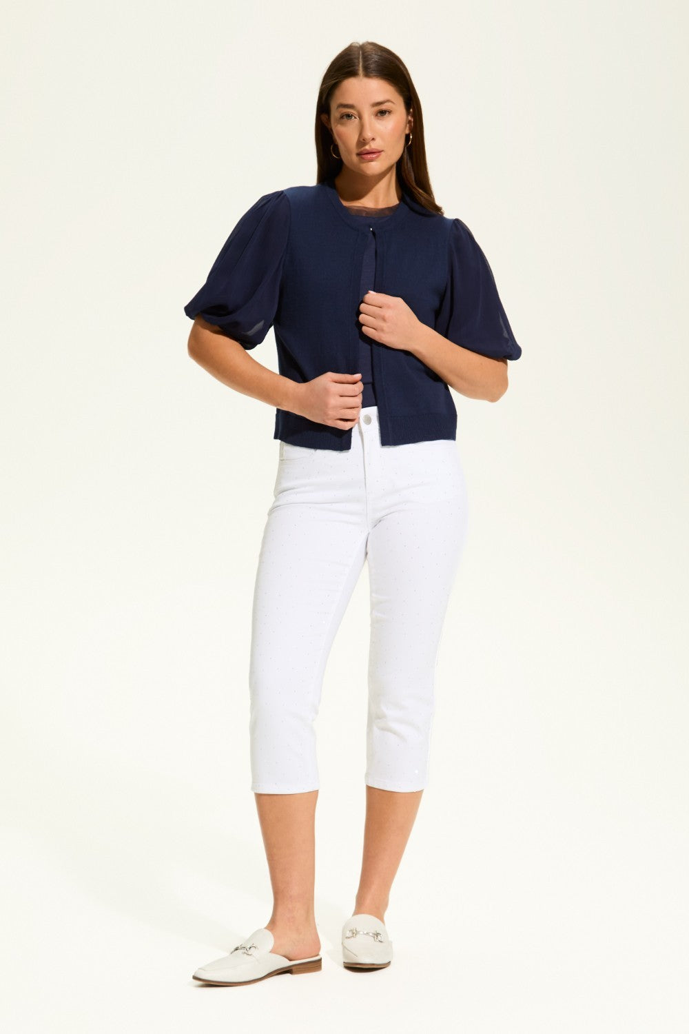 This versatile layering piece adds a touch of elegance to any outfit. The lightweight fabric provides a comfortable fit, while the sheer elbow length sleeves offer a stylish look. Perfect for dressing up or down, this cardigan is a must-have for any wardrobe.