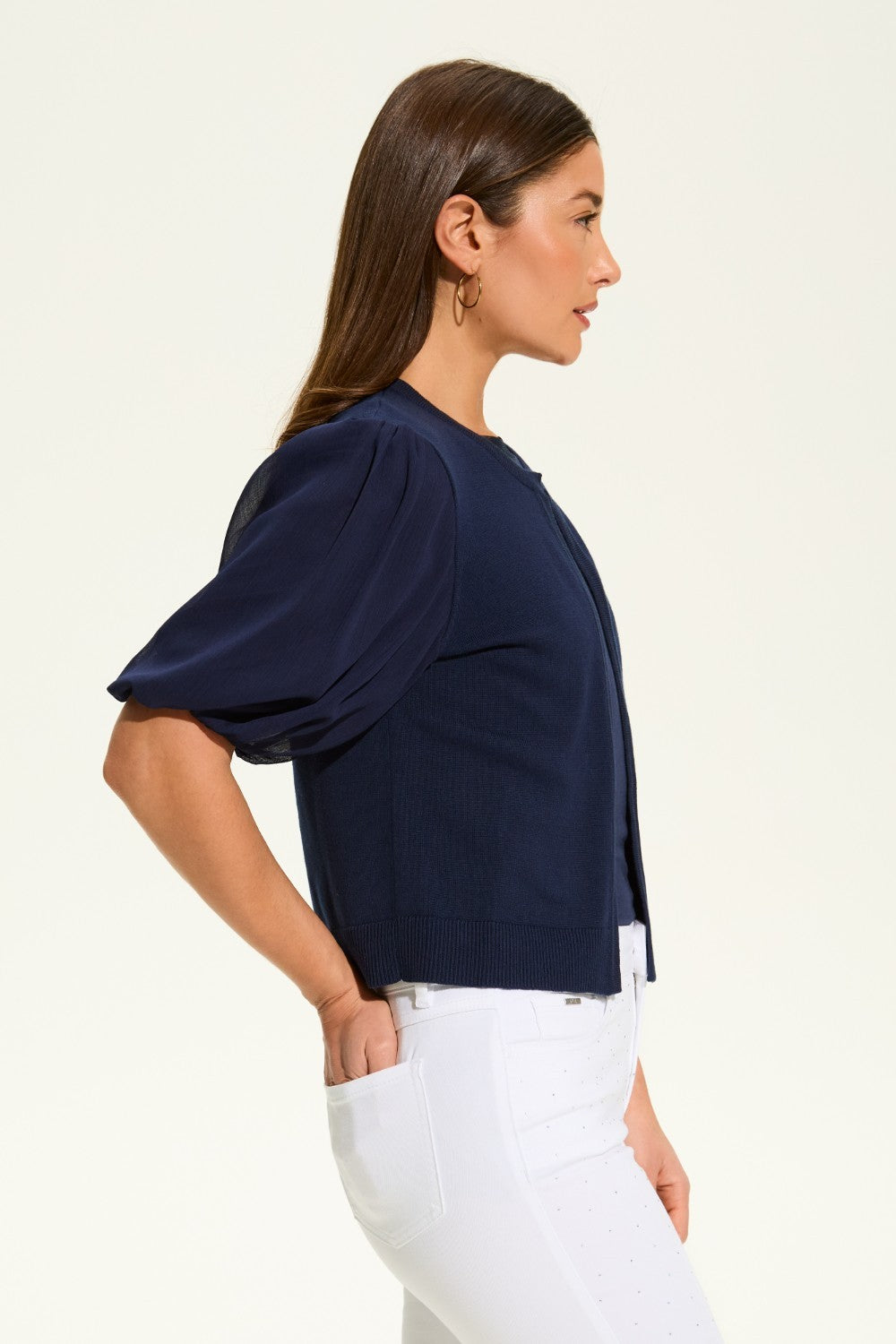 This versatile layering piece adds a touch of elegance to any outfit. The lightweight fabric provides a comfortable fit, while the sheer elbow length sleeves offer a stylish look. Perfect for dressing up or down, this cardigan is a must-have for any wardrobe.