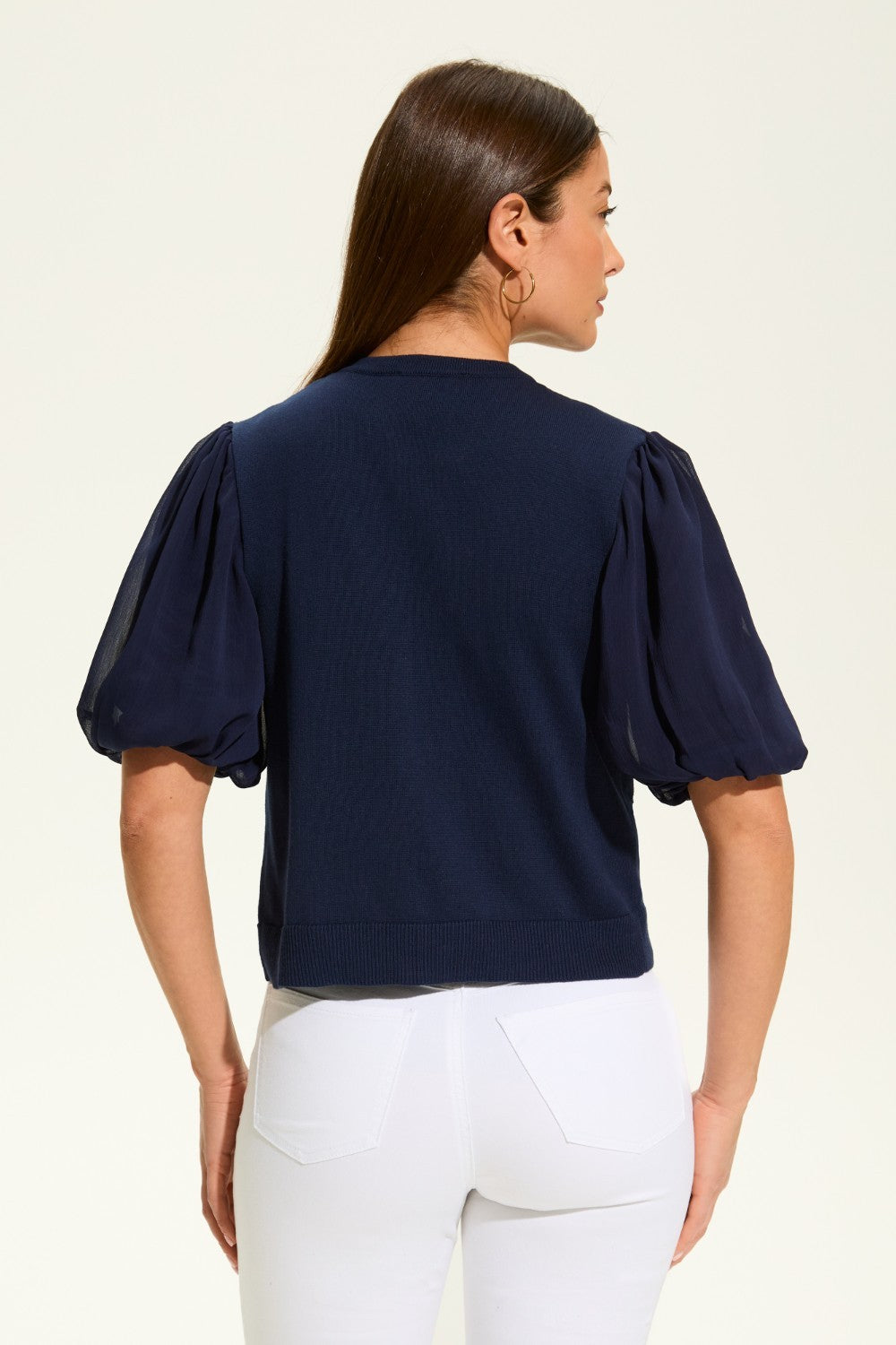 This versatile layering piece adds a touch of elegance to any outfit. The lightweight fabric provides a comfortable fit, while the sheer elbow length sleeves offer a stylish look. Perfect for dressing up or down, this cardigan is a must-have for any wardrobe.