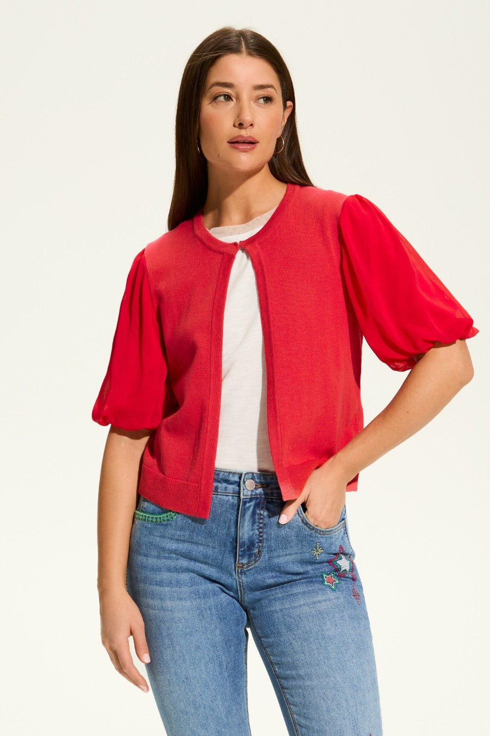 This versatile layering piece adds a touch of elegance to any outfit. The lightweight fabric provides a comfortable fit, while the sheer elbow length sleeves offer a stylish look. Perfect for dressing up or down, this cardigan is a must-have for any wardrobe.