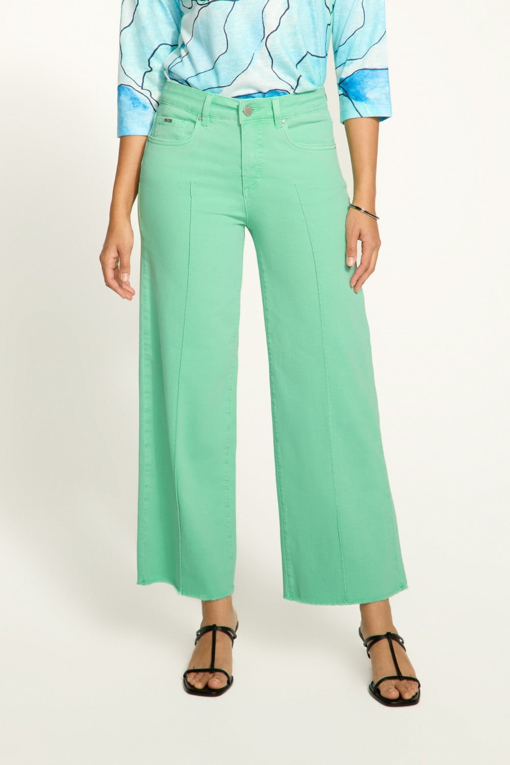 Introducing the FDJ Olivia Wide Ankle pants, designed to elevate your everyday style with its pintuck detailing and frayed bottom. These jeans are perfect for adding a touch of sophistication and edge to any outfit. Get ready to stand out from the crowd and make a statement with the FDJ Olivia Wide Ankle jeans!