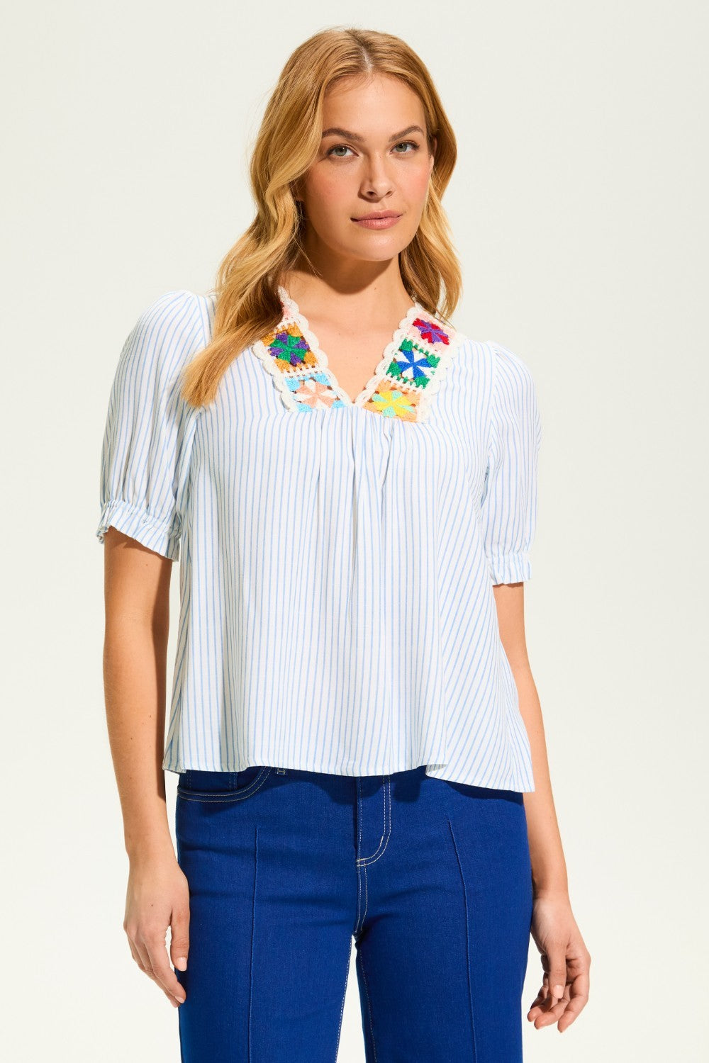 This FDJ V Neck Crochet Trim Blouse exudes boho chic style and pairs beautifully with denim. The intricate crochet trim adds a touch of femininity to this versatile blouse, making it a must-have for any fashion-forward wardrobe. Elevate your look with this stylish piece.