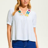 This FDJ V Neck Crochet Trim Blouse exudes boho chic style and pairs beautifully with denim. The intricate crochet trim adds a touch of femininity to this versatile blouse, making it a must-have for any fashion-forward wardrobe. Elevate your look with this stylish piece.