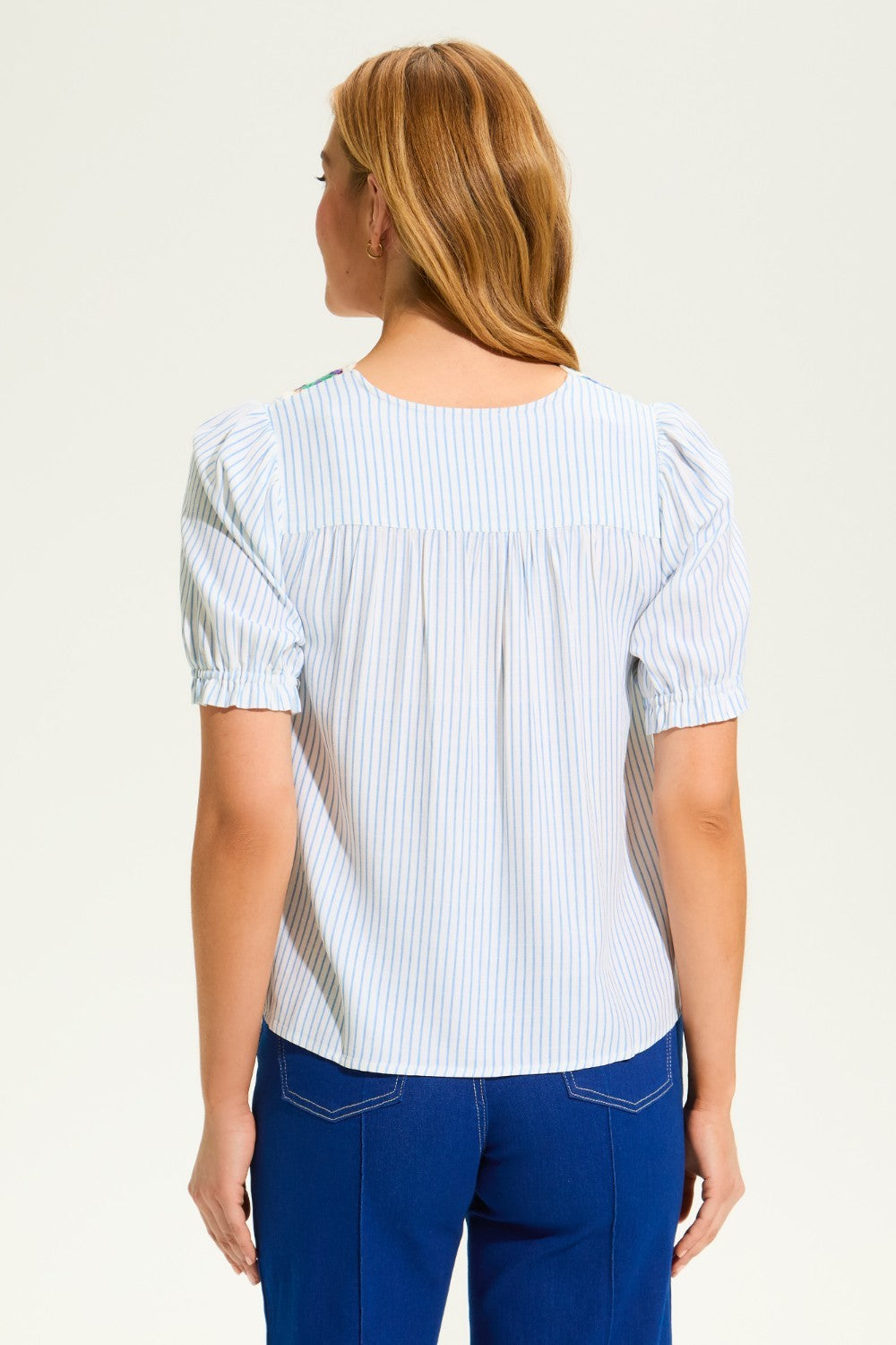 This FDJ V Neck Crochet Trim Blouse exudes boho chic style and pairs beautifully with denim. The intricate crochet trim adds a touch of femininity to this versatile blouse, making it a must-have for any fashion-forward wardrobe. Elevate your look with this stylish piece.