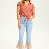 This 100% cotton top exudes effortless style with its eyelet lace detailing and playful tie at the front. A versatile choice for any casual occasion.