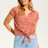 This 100% cotton top exudes effortless style with its eyelet lace detailing and playful tie at the front. A versatile choice for any casual occasion.