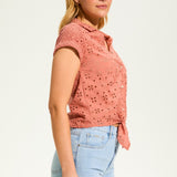 This 100% cotton top exudes effortless style with its eyelet lace detailing and playful tie at the front. A versatile choice for any casual occasion.