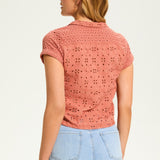 This 100% cotton top exudes effortless style with its eyelet lace detailing and playful tie at the front. A versatile choice for any casual occasion.