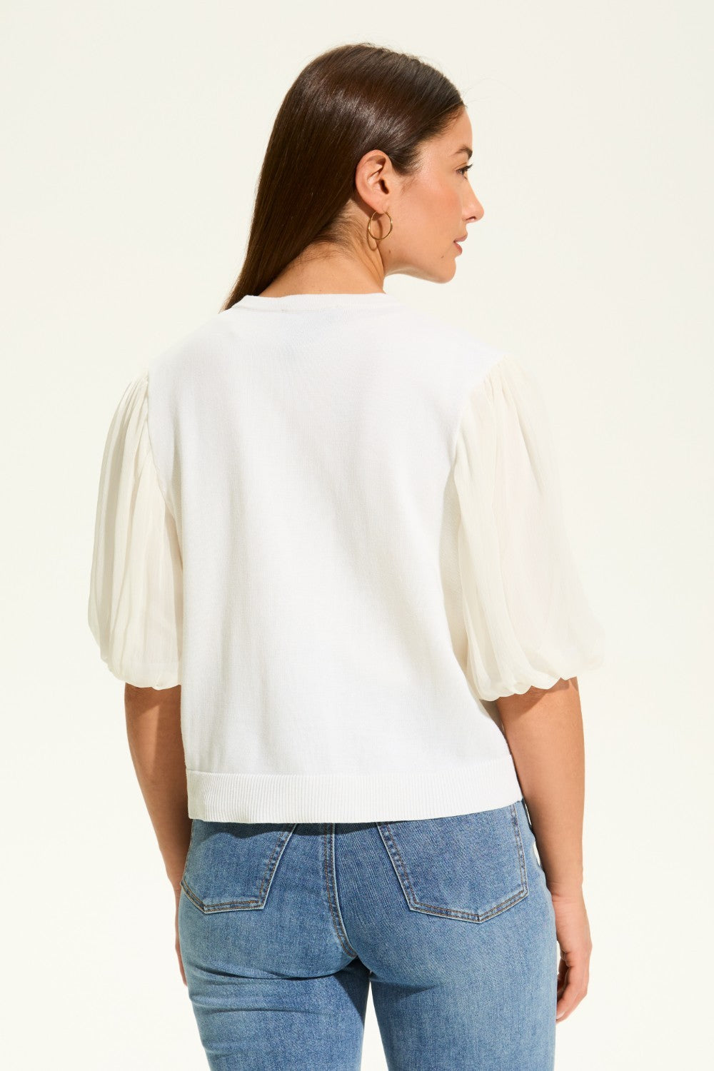 This versatile layering piece adds a touch of elegance to any outfit. The lightweight fabric provides a comfortable fit, while the sheer elbow length sleeves offer a stylish look. Perfect for dressing up or down, this cardigan is a must-have for any wardrobe.