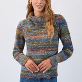 Woman wearing a multicolored sweater and blue jeans on a white background