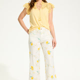 Brighten up your wardrobe with the FDJ Flutter Sleeve Placed Eyelet Top! This solid yellow top is sure to add a pop of colour to any outfit, making you look and feel cheery all day long. Don't miss out on this pretty piece.
