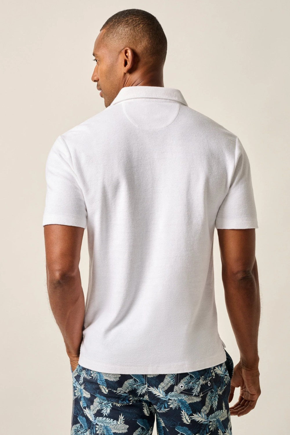 The ultimate poolside style, this terry polo harkens back to the day when lounging under a beach umbrella in the Hollywood Hills was a full-time job. It's made with a lighter version of the fabric used for ultra-luxe towels and it's made with a Johnny collar polo—a mark of the 60s worn by all your favorite style icons.