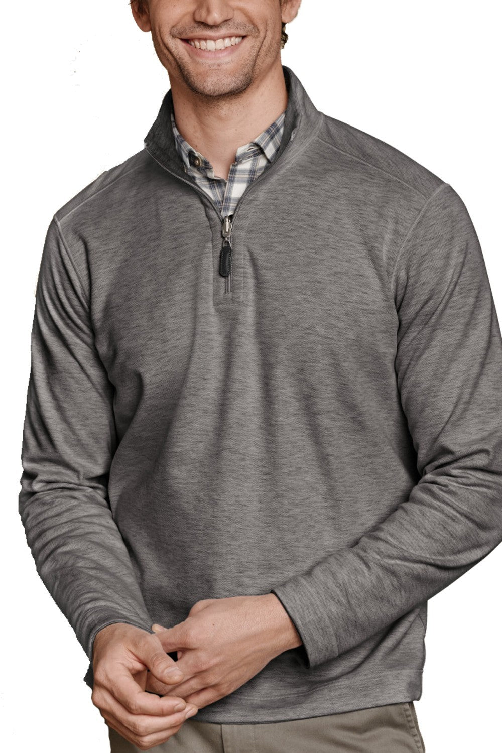 Man wearing a gray pullover with a plaid shirt underneath on a white background