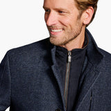Man wearing a dark blue coat with a white background